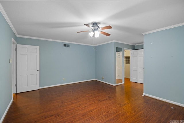 empty room featuring ceiling fan, dark wood-type flooring, and ornamental molding