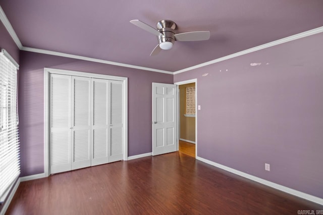 unfurnished bedroom with a closet, ceiling fan, dark hardwood / wood-style flooring, and crown molding