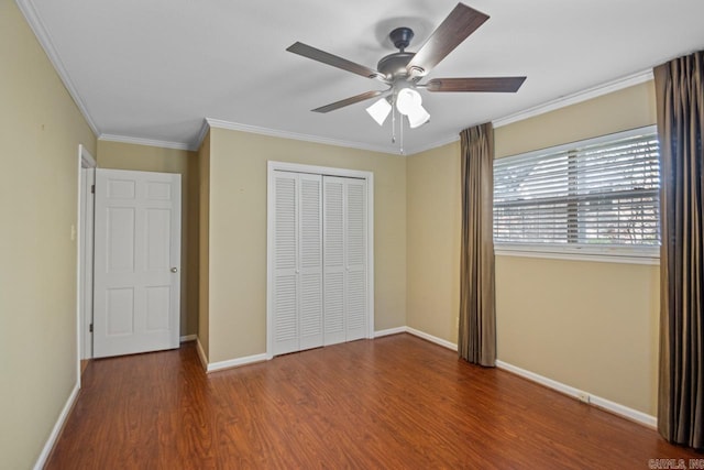 unfurnished bedroom featuring hardwood / wood-style flooring, ceiling fan, crown molding, and a closet