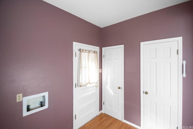 washroom featuring washer hookup and light hardwood / wood-style floors