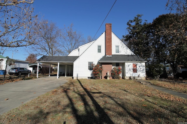 exterior space with a front lawn and a carport