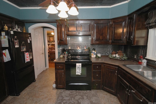 kitchen with dark brown cabinetry, black appliances, and ornamental molding