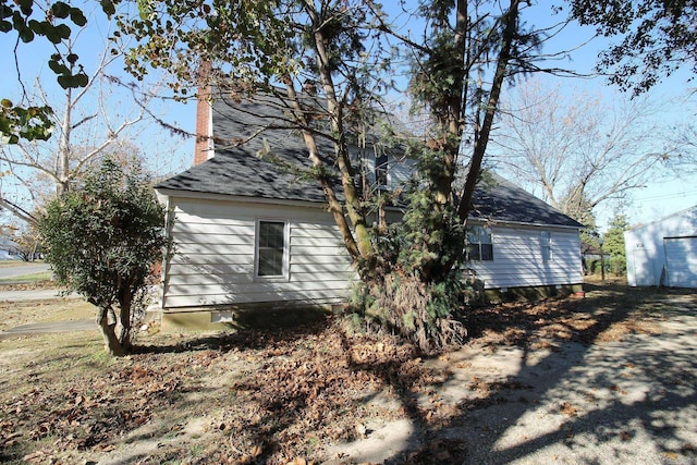 view of property exterior featuring an outdoor structure