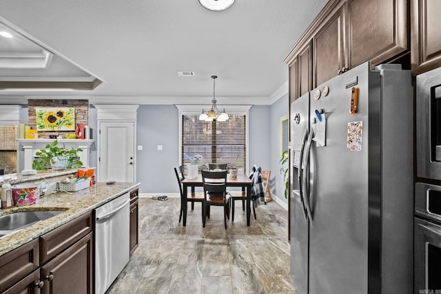 kitchen with dark brown cabinetry, hanging light fixtures, stainless steel appliances, a notable chandelier, and ornamental molding