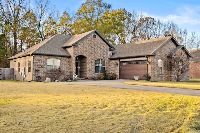 view of front of home with a front lawn and a garage