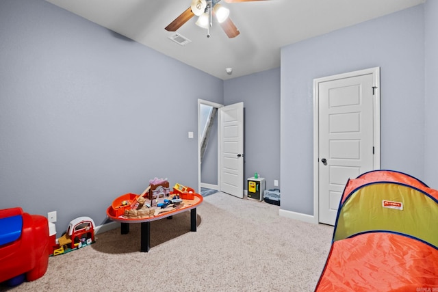 recreation room with carpet flooring and ceiling fan