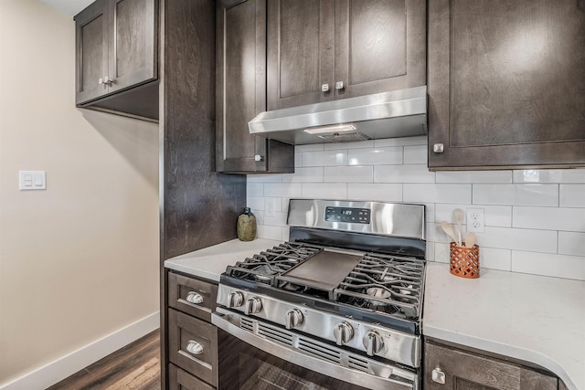 kitchen with dark brown cabinetry, dark hardwood / wood-style floors, and stainless steel range with gas stovetop