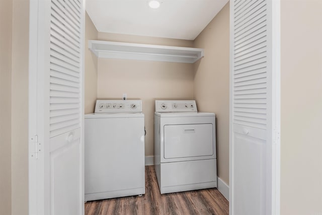 laundry area with washing machine and dryer and dark hardwood / wood-style floors