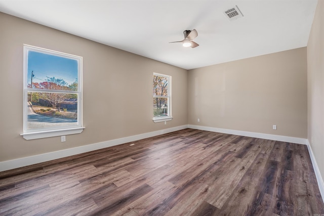 unfurnished room featuring ceiling fan and dark wood-type flooring