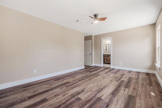 unfurnished bedroom featuring wood-type flooring, ensuite bathroom, and ceiling fan