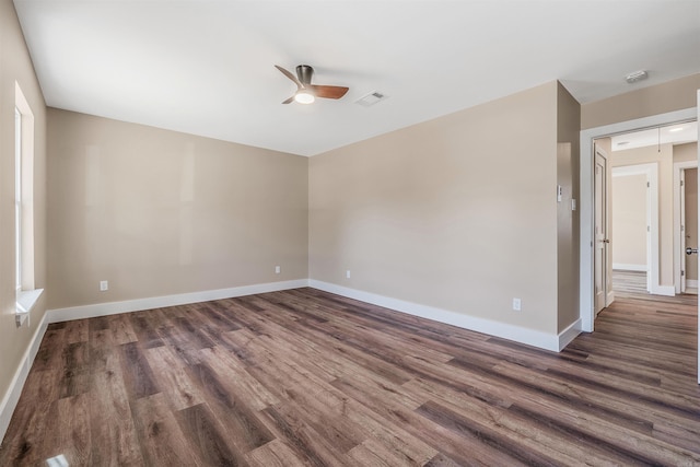 empty room featuring ceiling fan and dark hardwood / wood-style floors