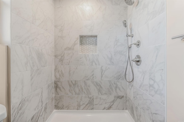 bathroom with tiled shower