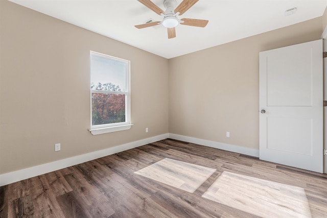 empty room with ceiling fan and light hardwood / wood-style floors