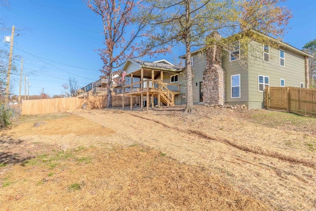 rear view of house featuring a wooden deck