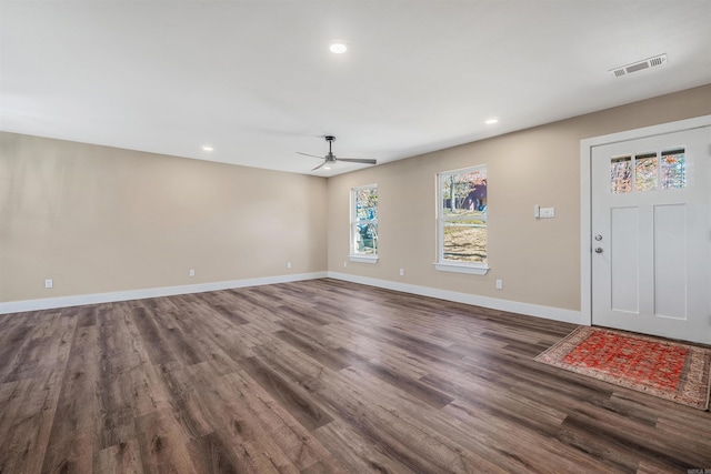 foyer entrance featuring ceiling fan and dark wood-type flooring