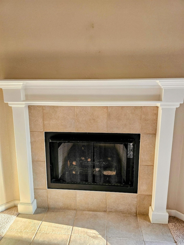 room details featuring a tiled fireplace