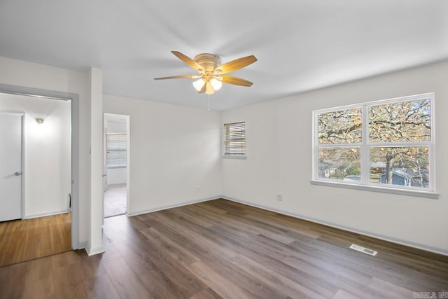 spare room featuring ceiling fan and dark hardwood / wood-style flooring