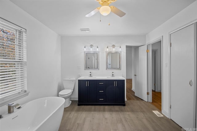 bathroom featuring hardwood / wood-style floors, a bathtub, ceiling fan, and vanity