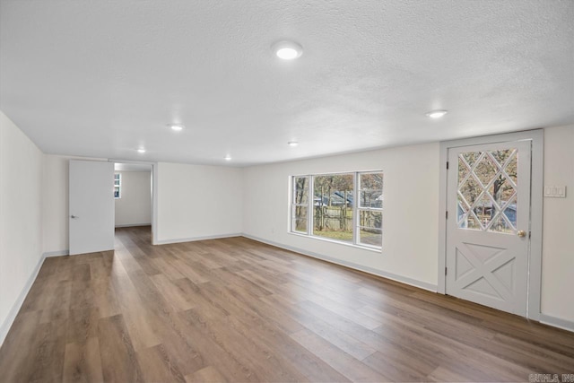 3630 Idlewild Ave, North Little Rock, AR 72116 - unfurnished living room with wood finished floors, healthy amount of natural light, recessed lighting, and a textured ceiling