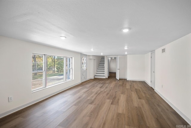 3630 Idlewild Ave, North Little Rock, AR 72116 - unfurnished living room featuring wood finished floors, stairs, recessed lighting, and a textured ceiling