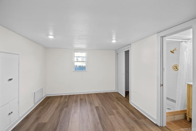 3630 Idlewild Ave, North Little Rock, AR 72116 - unfurnished bedroom with wood finished floors, ensuite bathroom, and a closet