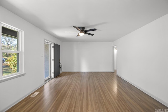 spare room with dark hardwood / wood-style floors and ceiling fan