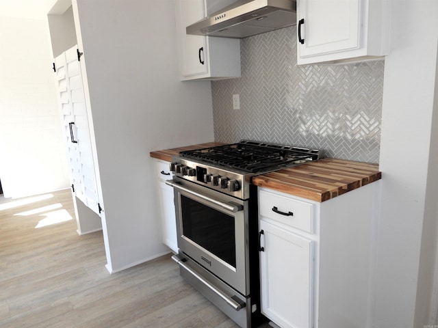 kitchen featuring high end range, wood counters, wall chimney exhaust hood, light hardwood / wood-style flooring, and white cabinets