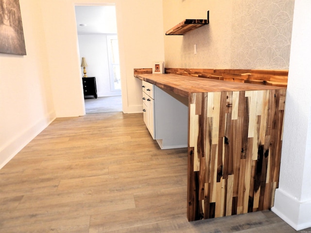 corridor with light hardwood / wood-style flooring