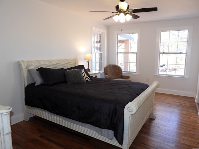 bedroom with ceiling fan and dark wood-type flooring