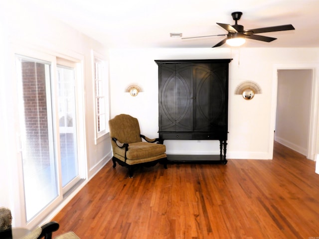 living area with hardwood / wood-style flooring and ceiling fan