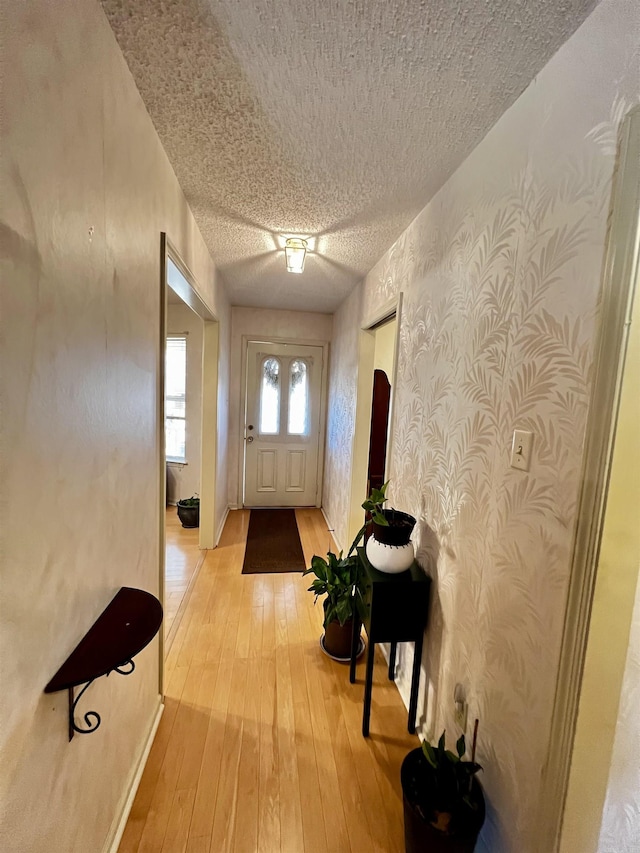 entryway featuring light hardwood / wood-style flooring and a textured ceiling