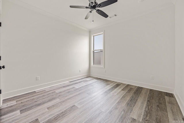 unfurnished room with crown molding, ceiling fan, and light hardwood / wood-style floors