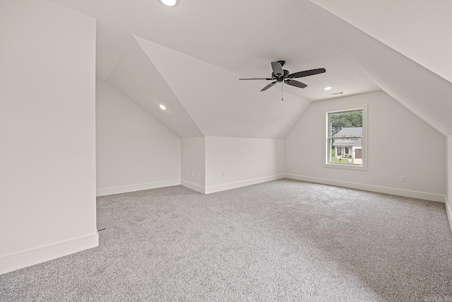 additional living space featuring carpet flooring, ceiling fan, and lofted ceiling