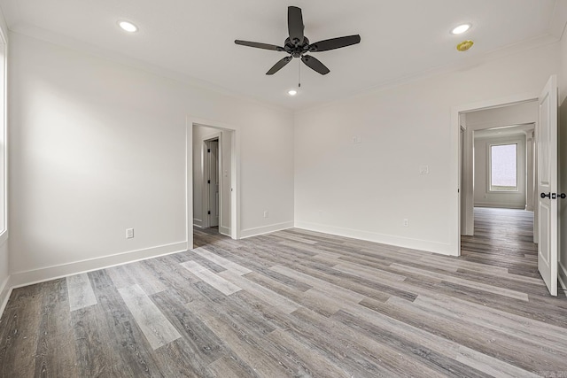 spare room with ceiling fan, ornamental molding, and light hardwood / wood-style flooring