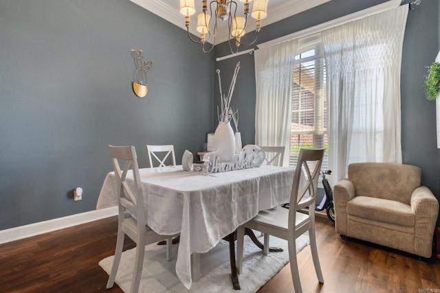 dining room featuring dark hardwood / wood-style flooring, a chandelier, and ornamental molding