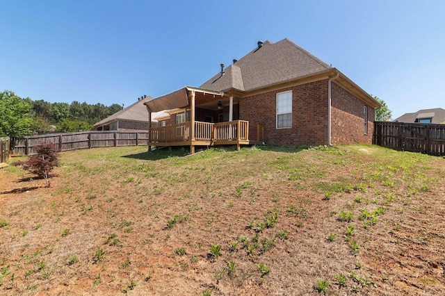 back of house featuring a yard, a deck, and ceiling fan