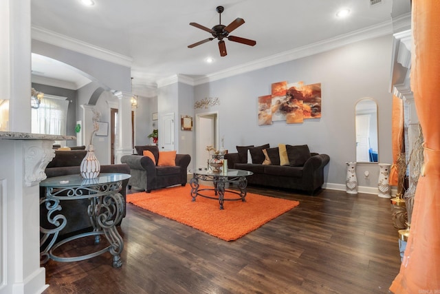 living room featuring dark hardwood / wood-style floors, ceiling fan, ornamental molding, and ornate columns