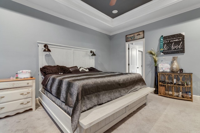 bedroom featuring ceiling fan, a raised ceiling, ornamental molding, and light carpet