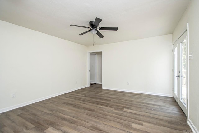 empty room with ceiling fan and dark hardwood / wood-style floors