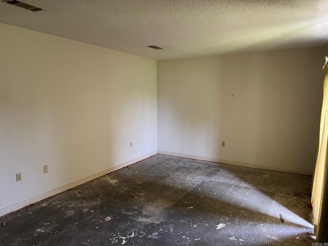 empty room featuring a textured ceiling