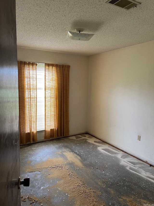 empty room featuring a textured ceiling