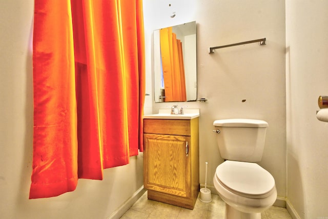 bathroom with tile patterned flooring, vanity, and toilet