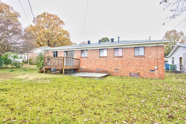 back of property with a yard, a patio, and a wooden deck