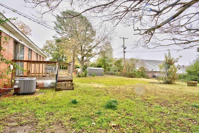 view of yard with central AC and a wooden deck