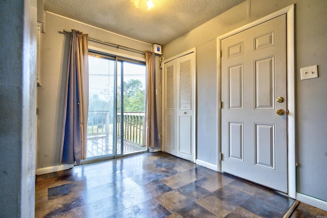 entryway with a textured ceiling