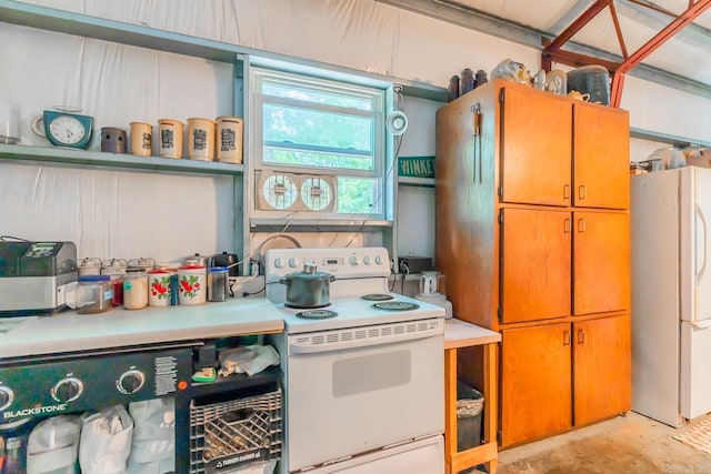 kitchen with stainless steel fridge and white electric stove