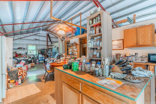 kitchen featuring vaulted ceiling with beams and white fridge