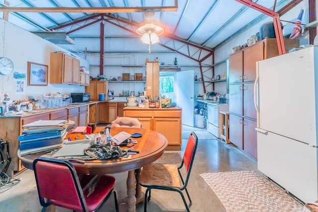 kitchen featuring vaulted ceiling and white appliances