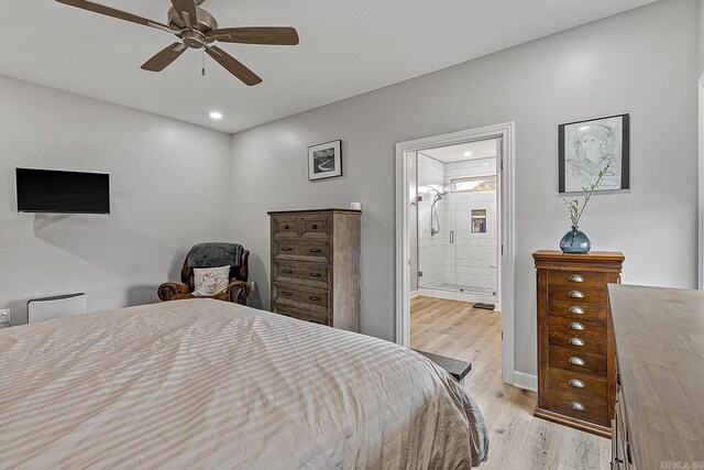 bedroom featuring ceiling fan, ensuite bathroom, and light hardwood / wood-style floors