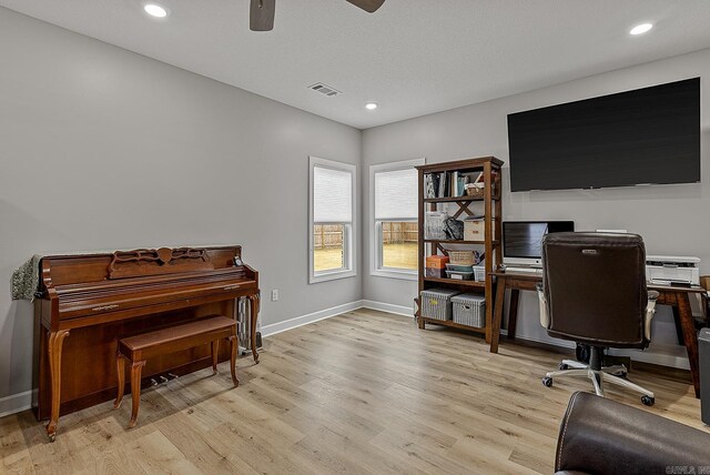 office area with ceiling fan and light hardwood / wood-style floors